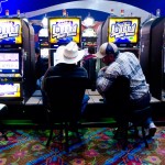 Two patrons sit at video slot machines in the Northern Winz Casino. The casino, which faltered for most of its first five years, is finally starting to turn a profit for the Chippewa-Cree tribe on Rocky Boy’s Reservation.