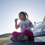 Nevaeh Fisher, 4, blows bubbles outside of her great-grandmother Elizabeth Stewart’s home in Crow Agency. Stewart secured the home through the Section 184 Indian Home Loan Guarantee Program.