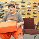 Azarian Bear, 12, of Wolf Point tries on shoes at Bryan's, the only large clothing store on the Fort Peck Reservation. Employees say their biggest sellers are shoes and children's toys. Otherwise, the store's relatively high prices discourage many people on the reservation from shopping there.