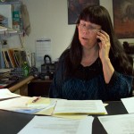Colleen Hill, the Little Shell Chippewa treasurer, makes phone calls in her basement office to put together the upcoming powwow. Hill says she spends about 30 hours a week working on Little Shell business.