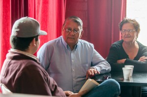 Roger Running Crane, center, talks with fired appellate Judge Julene Kennerly, right, and Shawn Augare shortly after a deal was struck between the Log Cabin Council and the Sharp Faction to pay tribal employees.