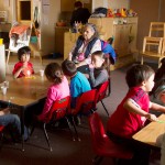 Geraldine Doney sits with kids while they brush their teeth during quiet time. Quiet time starts when the lights go off, but the kids have a hard time sitting still and not talking. Doney and the teachers often have to remind the kids to be quiet.