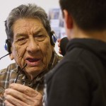 Antone Rider helps his great-grandfather, Gilbert Horn, 90, remove the headset that helps him hear. Horn moved from his home in Fort Belknap Agency to the Northern Montana Care Center in Havre in February 2013.