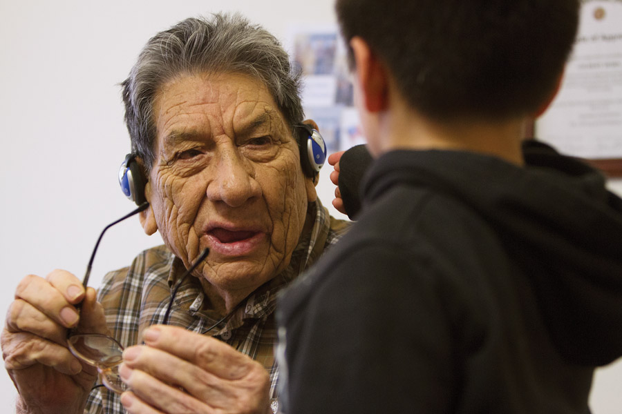 Antone Rider helps his great-grandfather, Gilbert Horn, 90, remove the headset that helps him hear. Horn moved from his home in Fort Belknap Agency to the Northern Montana Care Center in Havre in February 2013. 