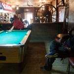Ryan White Horse takes a nap during his friend Melvin Martell’s 2 p.m. pool game at Arlo’s Bar in Wolf Point.