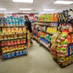 Floyd Bearing, the financial manager of the Cheyenne Depot, restocks one of the cases of chips at the largest convenience store on the reservation. "Chips, chips, chips," said Kay Medicine Bull when asked about the most popular food on the Northern Cheyenne Indian Reservation.