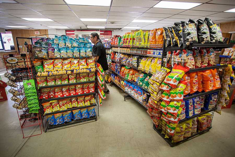 Floyd Bearing, the financial manager of the Cheyenne Depot, restocks one of the cases of chips at the largest convenience store on the reservation. "Chips, chips, chips," said Kay Medicine Bull when asked about the most popular food on the Northern Cheyenne Indian Reservation. 