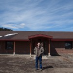 Major Robinson stands in front of the new Northern Cheyenne Utilities Center in Lame Deer. Robinson helped turn what was once a swimming pool changing room into a new facility for utilities workers. He also brought on many Northern Cheyenne tribal members in need of work to help remodel the building.