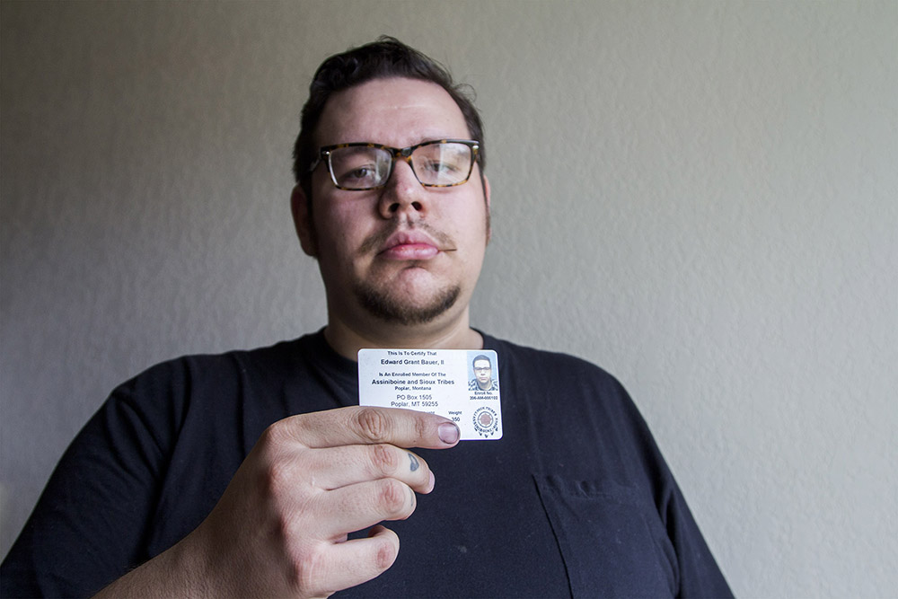 Eddie Bauer holds his tribal identification card, which identifies him as an associate member of the Fort Peck Assiniboine and Sioux Tribes. Eddie is currently studying Nakoda language at Fort Peck Community College.