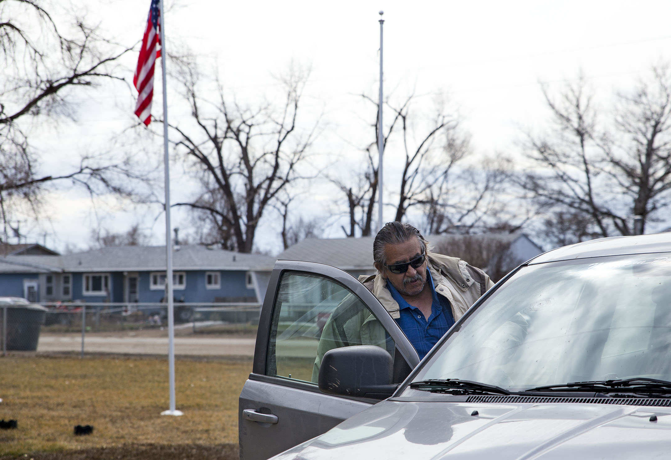 Mitchell Headdress gets into a van that takes him to his appointment at the VA clinic in Miles City. He is one of many veterans on the reservation that take advantage of the tribally-run transportation program. 