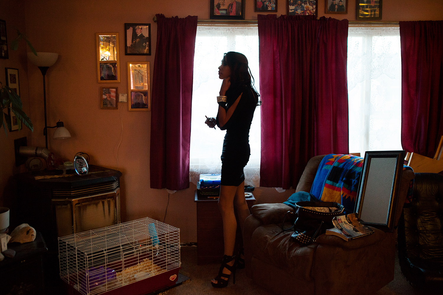 Dale standing in her living room wearing her prom dress.