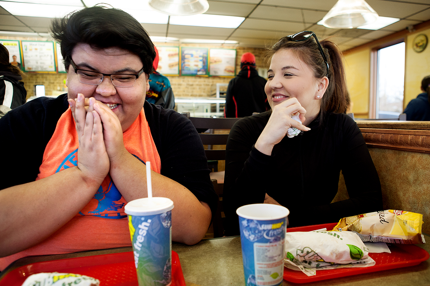 Dakota and his cousin, Kayla, laugh and eat at a Subway in Browning, Montana.