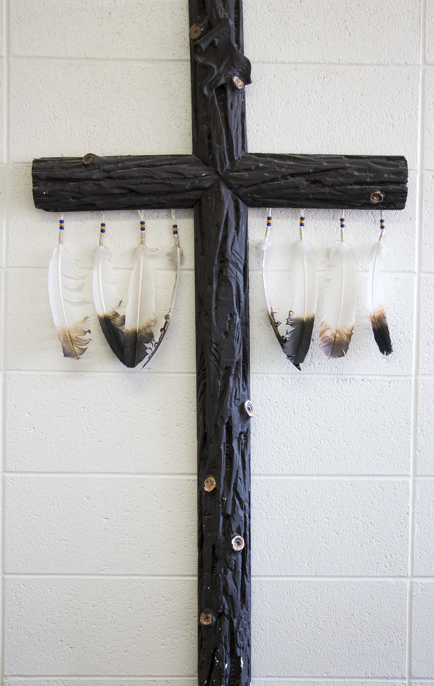 A cross hanging on a wall in St. Charles Mission, a Catholic Church on the Crow Reservation
