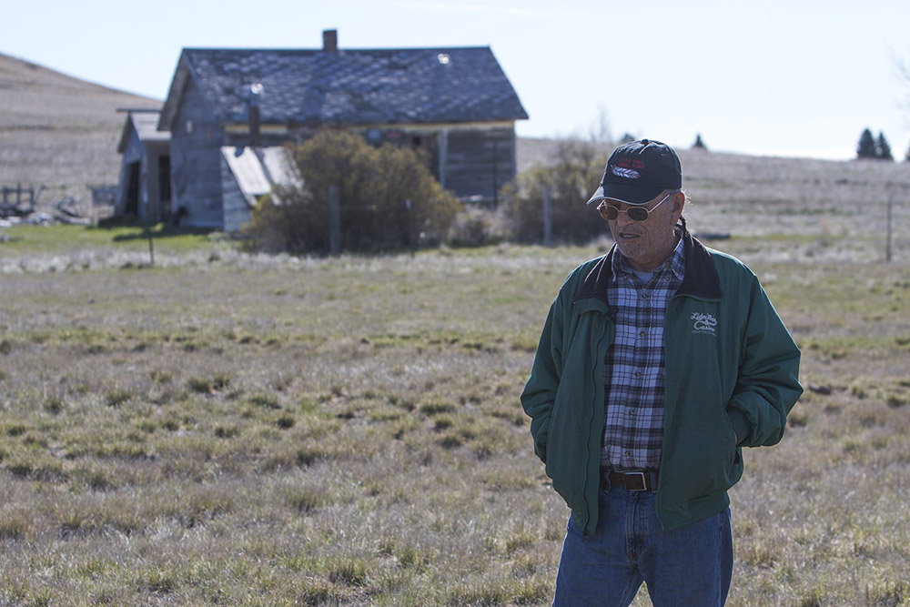 Jay Jarvis stands in front of an old derelict house on Hill 57. Jarvis was born on Hill 57 in 1948 and has spent most of his life there. He calls it home, despite the hardships that came with growing up there.