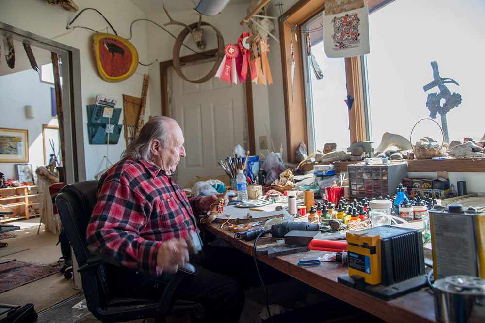 Darrell Norman, a traditional Blackfeet artist, works on an elk fetish in his studio just outside of Browning. The artist has been involved in the constitution reform process since the first attempt in the 1970s and remains optimistic.