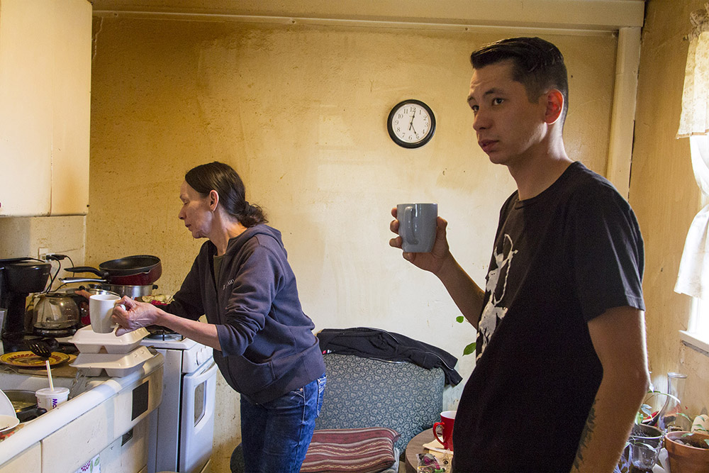 Francis Bauer, right, waits for his mother, Joni McClammy, to finish pouring her coffee before leaving to run errands in Poplar, Montana.