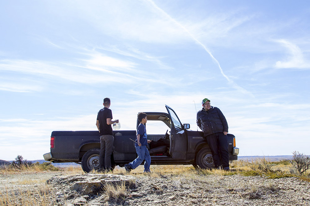 Francis Bauer, his son, Killian, and his brother Eddie spend the afternoon exploring the badlands just south of Poplar, Montana.