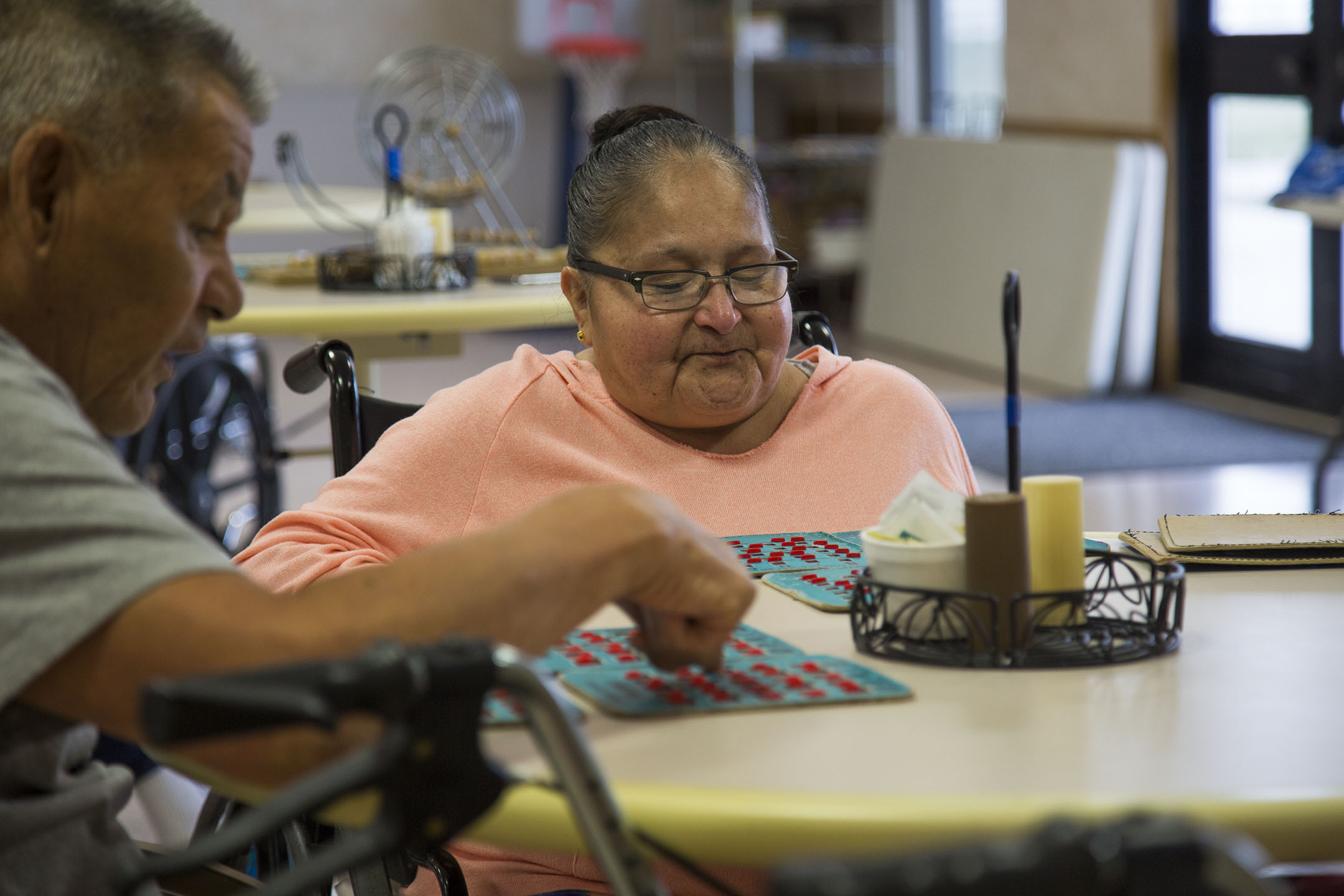 TroyLnn Shotgunn, right, and her father, Kenneth Beartusk, left, play bingo at the Awe Kualawaache Care Center on the Crow Reservation. The center offers activities for its residents, including trips to the Sheridan Rodeo and the Crow Fair.