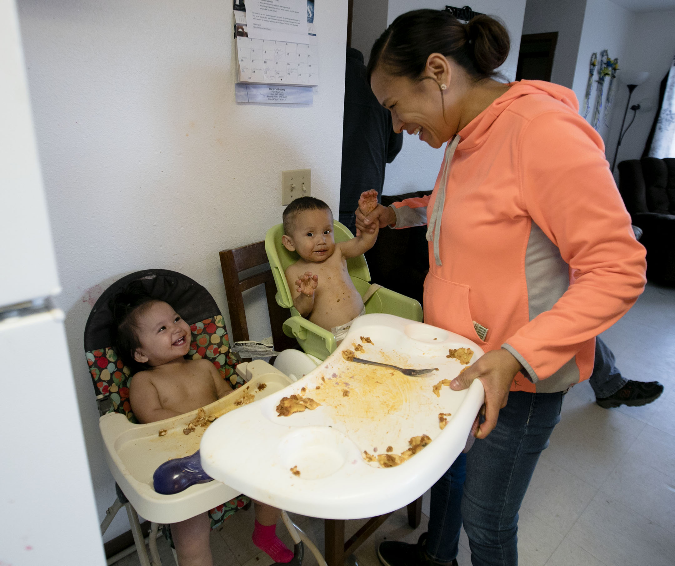 Jean Bear feeds her children, Hazel and Kale, while celebrating her 30th birthday at her home in Hays. Her pregnancy with the twins was considered high risk and she was able to sign up for Medicaid to help cover the costs of care.