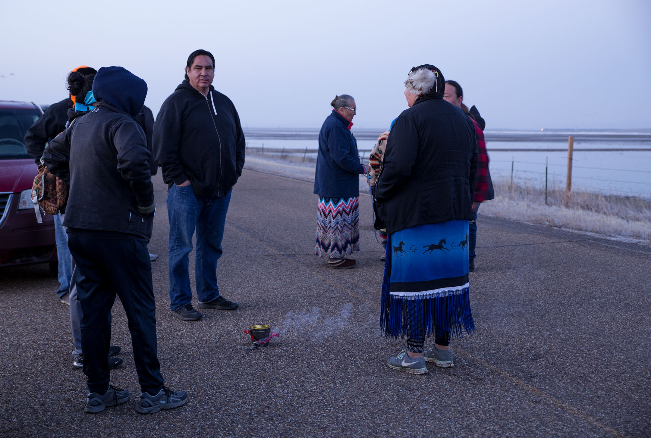 Lance Four Star, center, joins other members of the community in a water prayer during sunrise before they walk 100-miles, from the eastern to western border of the reservation, in protest of the Keystone XL pipeline on March 24, 2017.