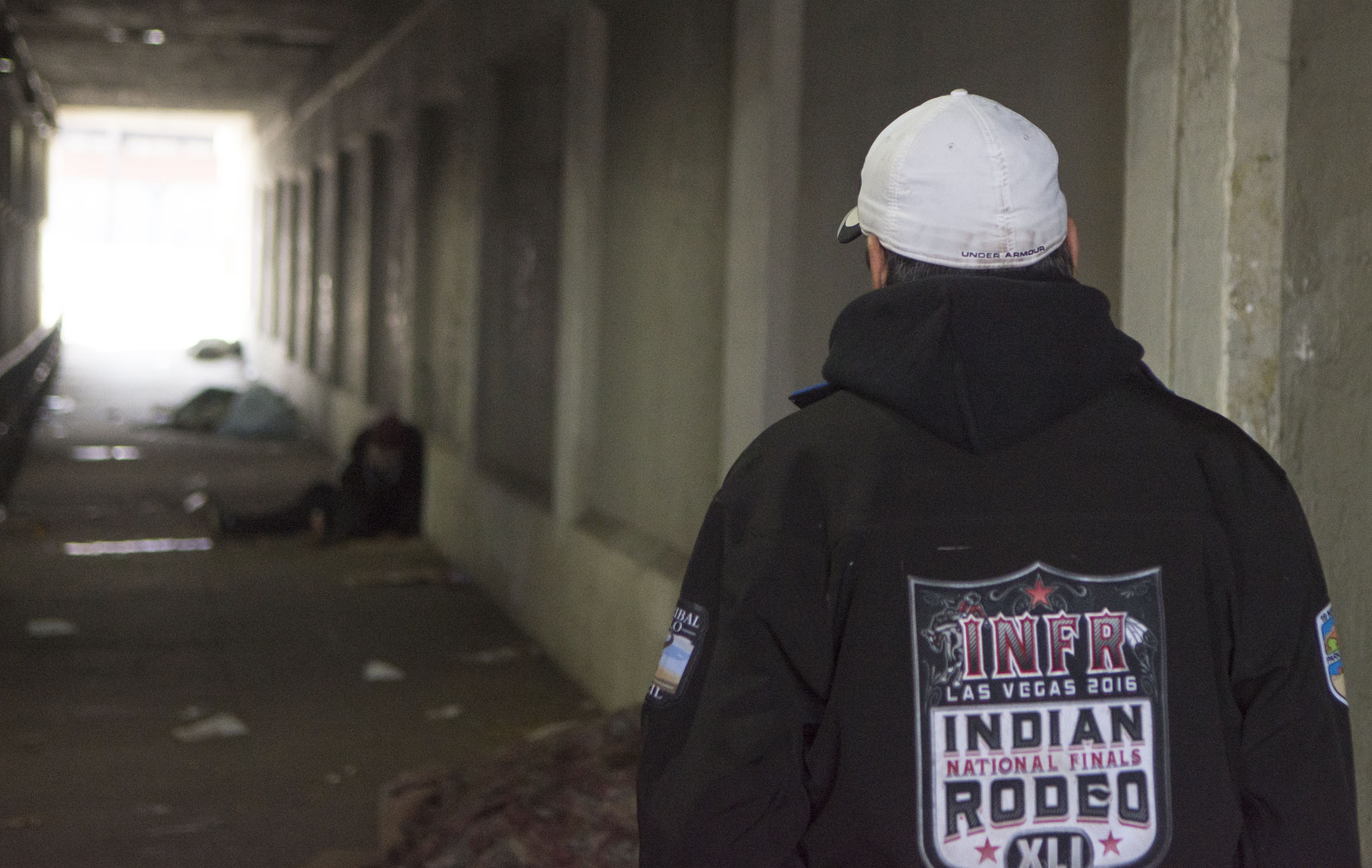 Loren BirdRattler strolls through an underpass in downtown Spokane where several homeless people have taken refuge.